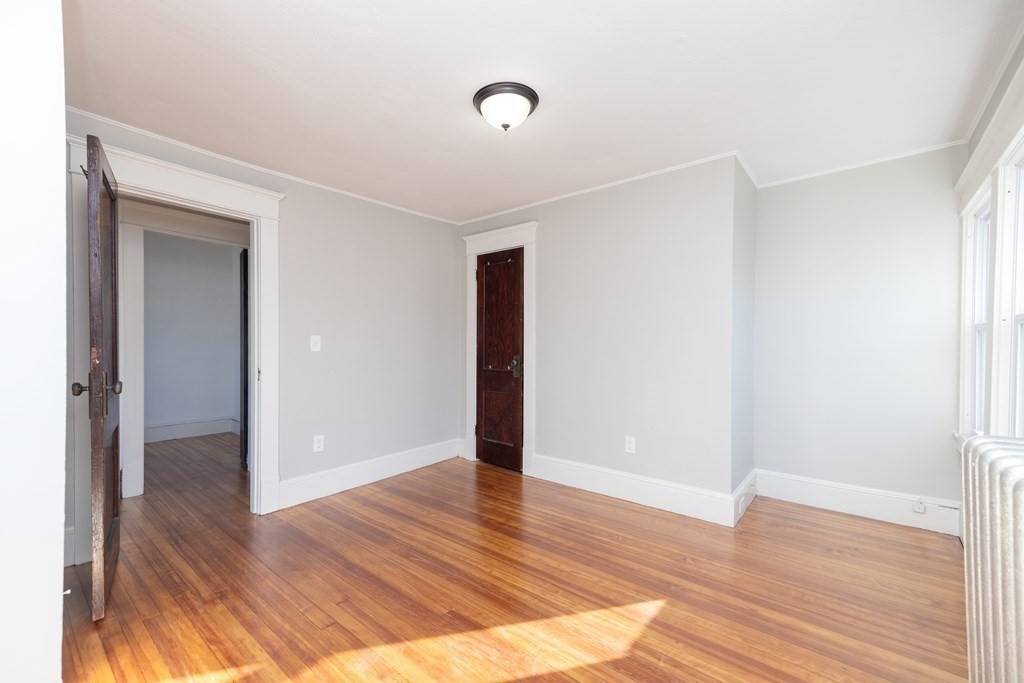 25 Daviston Street Springfield, MA 01108 - Photo 23 of 42 a view of an empty room with wooden floor