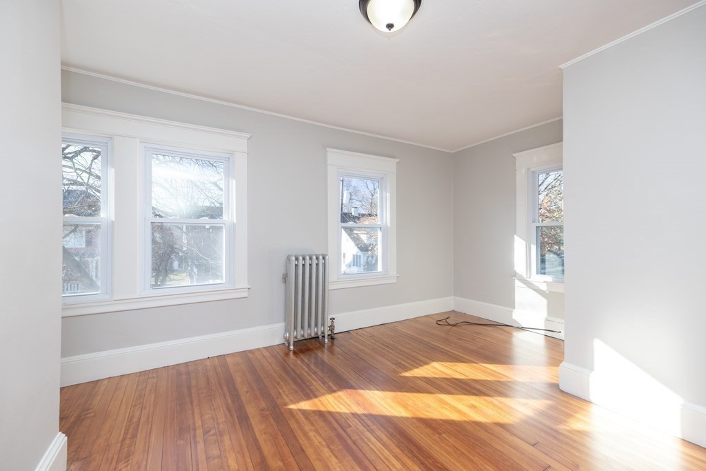 25 Daviston Street Springfield, MA 01108 - Photo 24 of 42 an empty room with wooden floor and windows