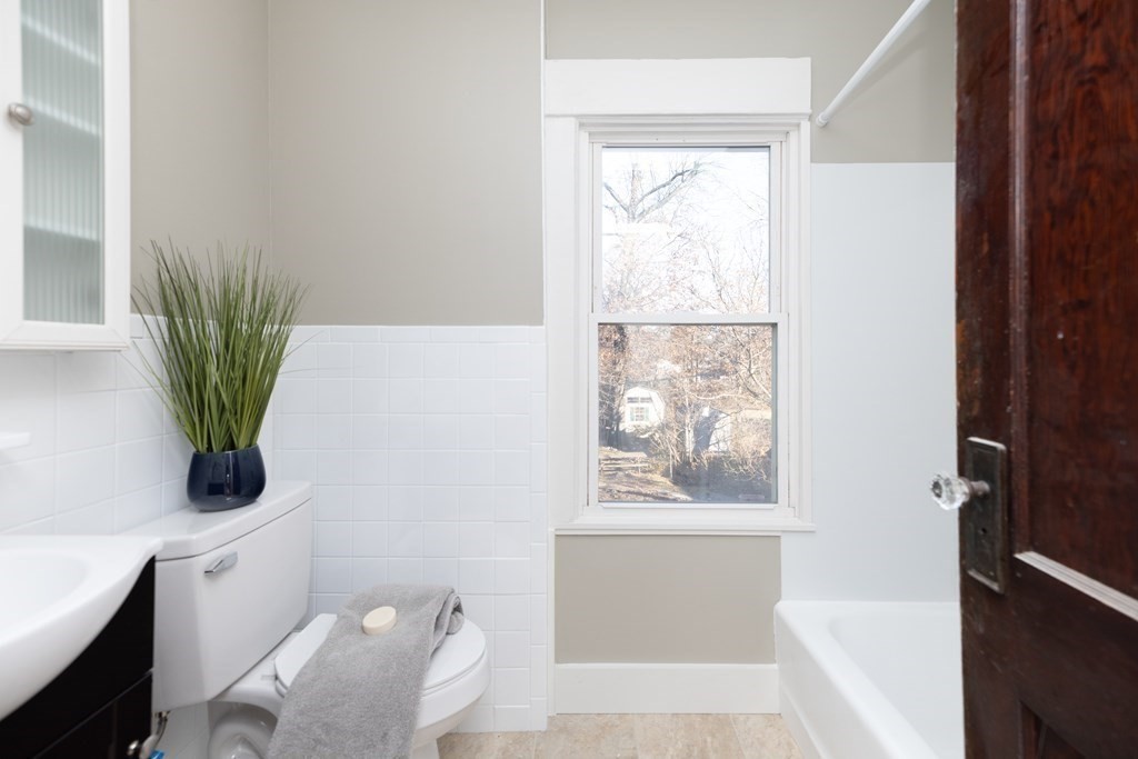 25 Daviston Street Springfield, MA 01108 - Photo 25 of 42 a bathroom with a toilet a sink and a window