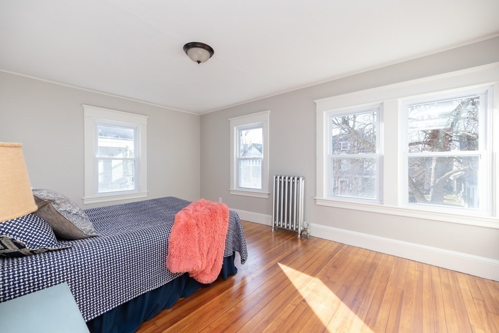 25 Daviston Street Springfield, MA 01108 - Photo 26 of 42 a bedroom with a bed and wooden floor