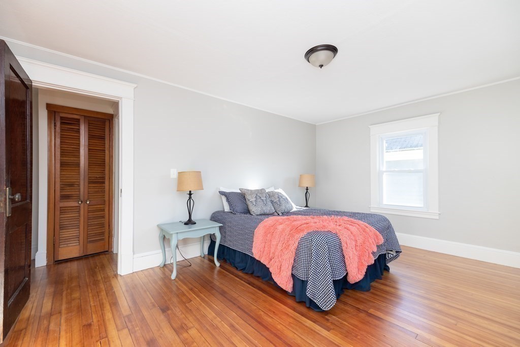 25 Daviston Street Springfield, MA 01108 - Photo 27 of 42 a bedroom with a bed and wooden floor