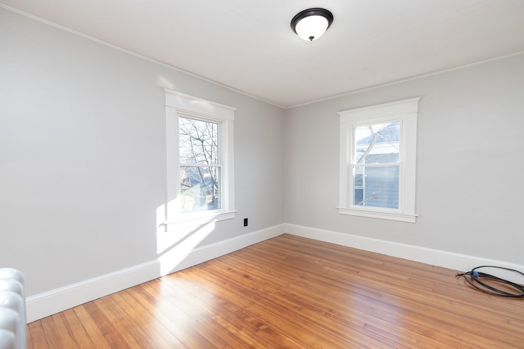 25 Daviston Street Springfield, MA 01108 - Photo 29 of 42 an empty room with wooden floor and windows