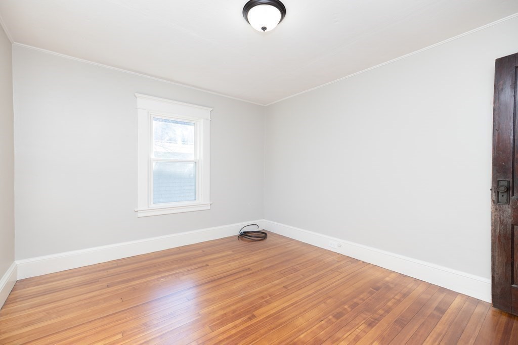 25 Daviston Street Springfield, MA 01108 - Photo 30 of 42 an empty room with wooden floor and windows