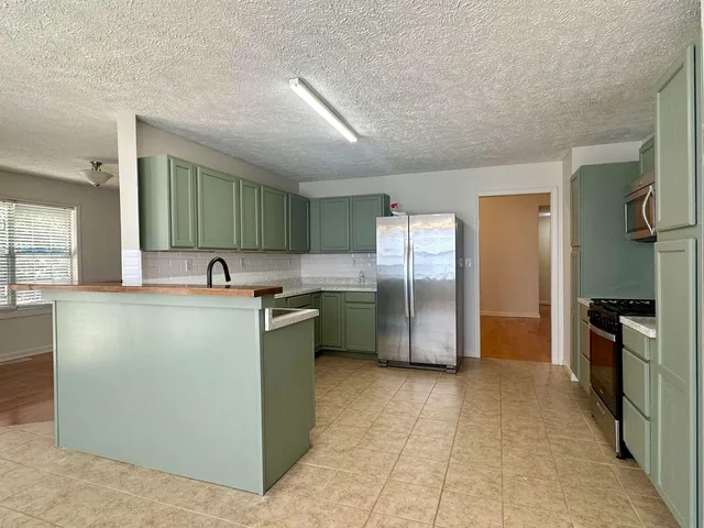 a kitchen with a refrigerator sink and stove