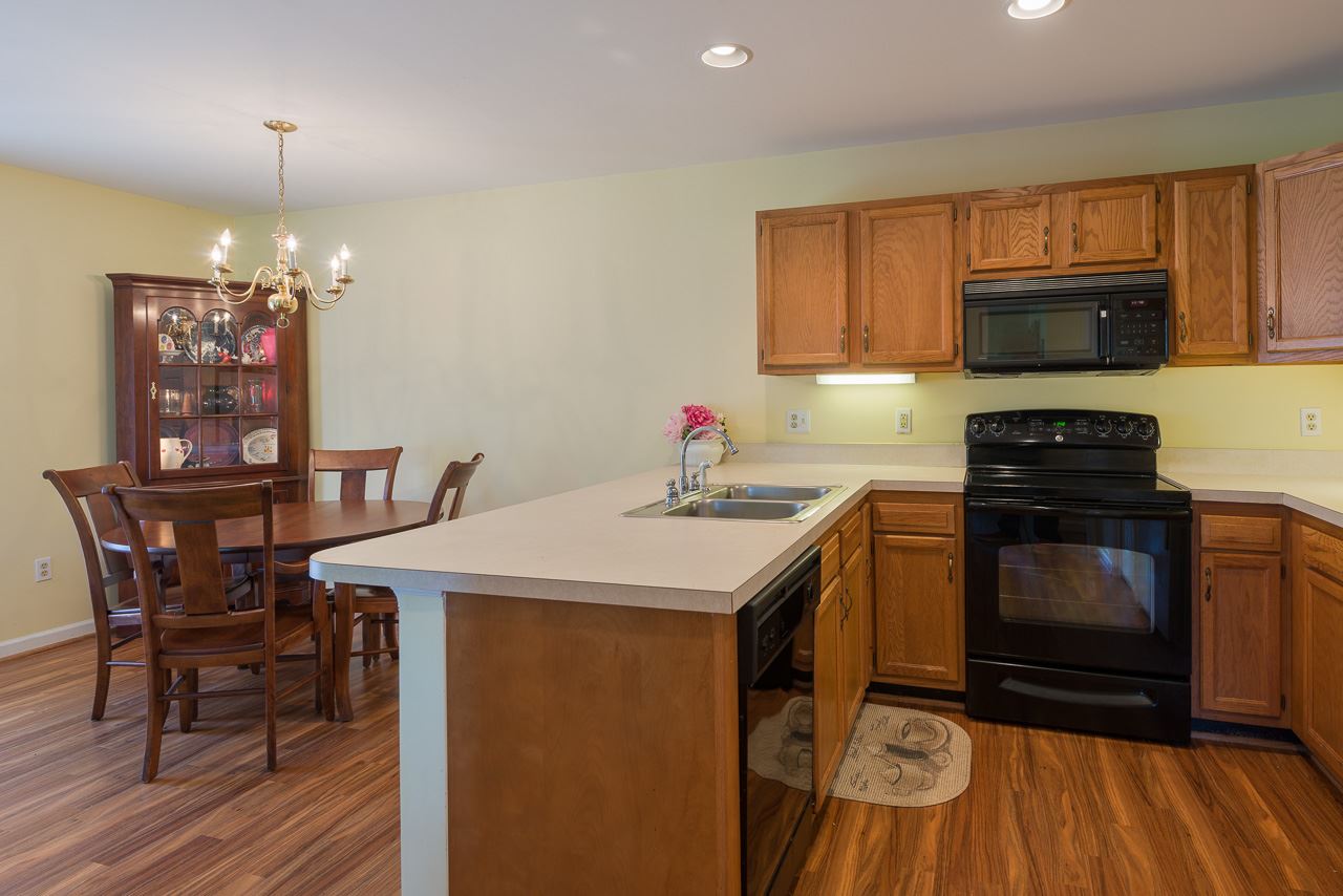 1053 Amber Ridge Road Charlottesville, VA 22901 - Photo 5 of 13 a kitchen with a sink cabinets and wooden floor