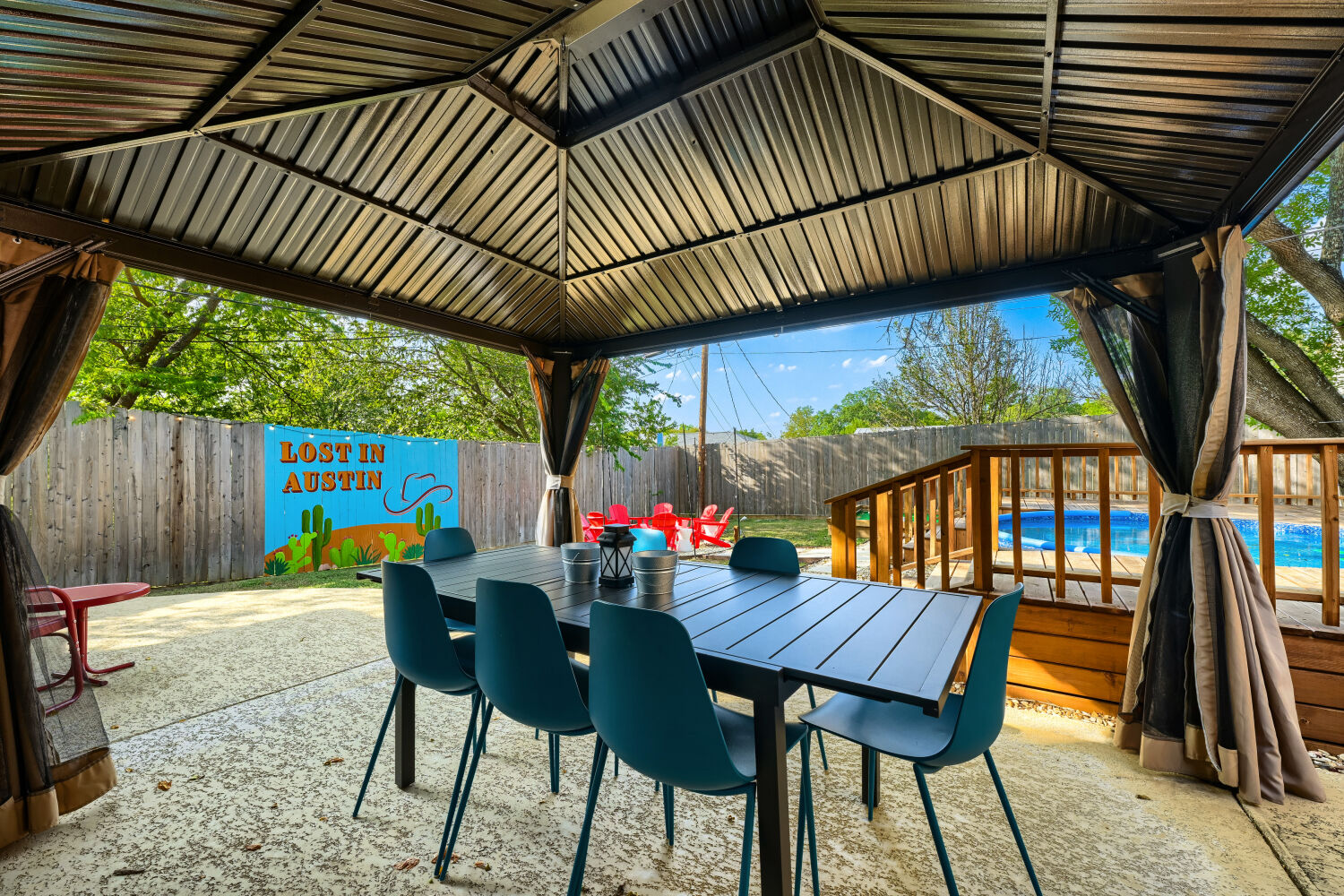 3410 Plantation Road Austin, TX 78745 - Photo 29 of 33 An inviting outdoor dining area features a gazebo, concrete patio, and fenced-in backyard with a pool.