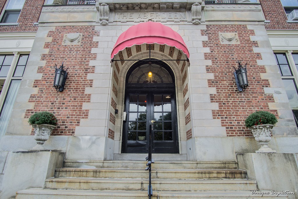 a view of building with glass windows and potted plants