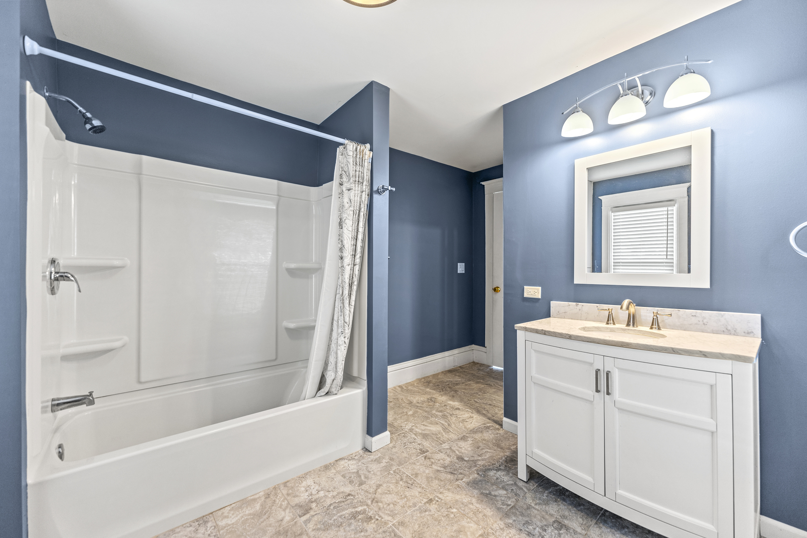 7496 Wolf Road Kingston, IL 60145 - Photo 12 of 38 a bathroom with a bathtub sink vanity and mirror