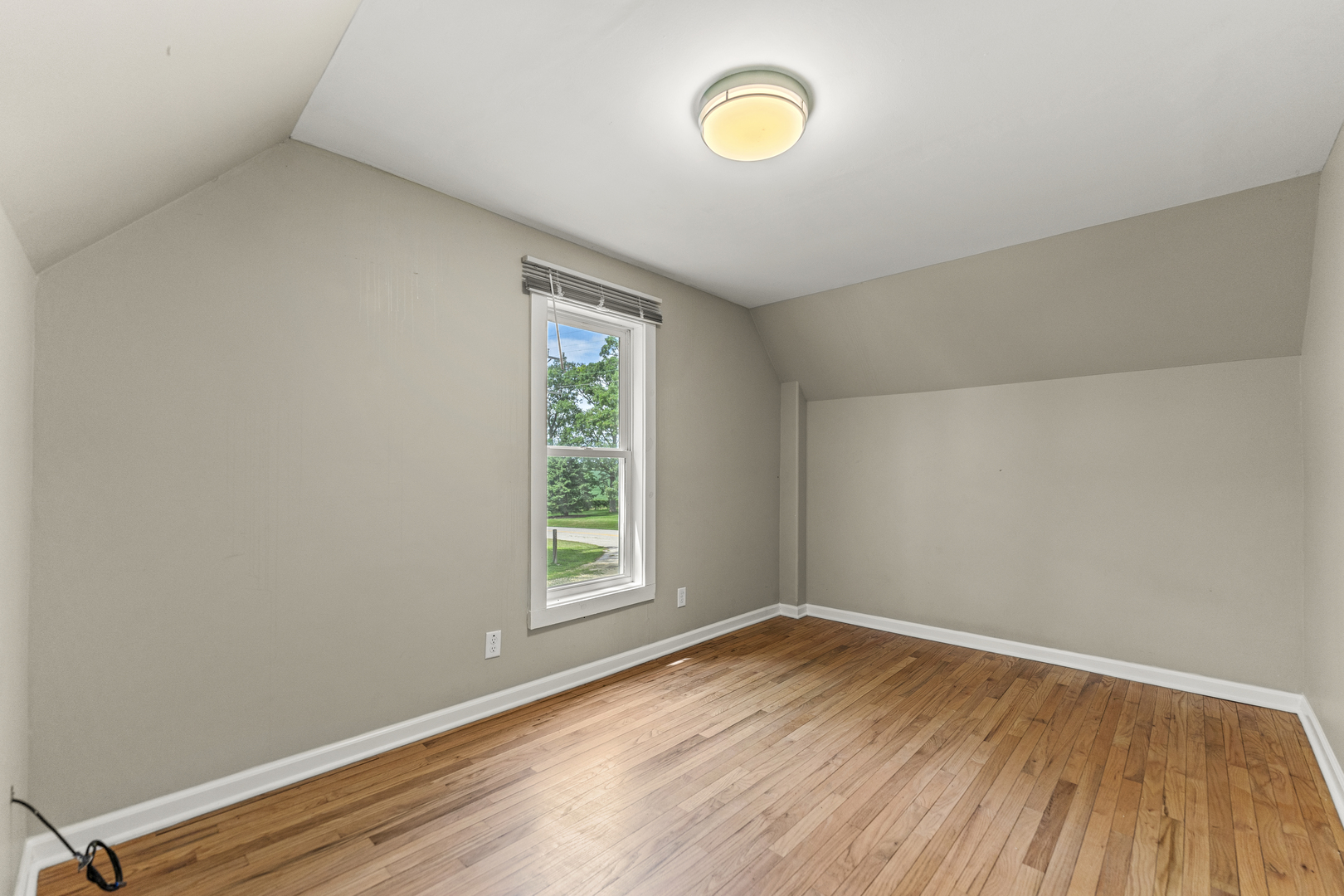 7496 Wolf Road Kingston, IL 60145 - Photo 17 of 38 an empty room with wooden floor and windows