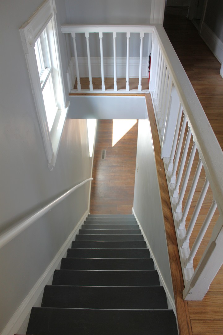 7496 Wolf Road Kingston, IL 60145 - Photo 21 of 38 a view of staircase with wooden floor and white walls