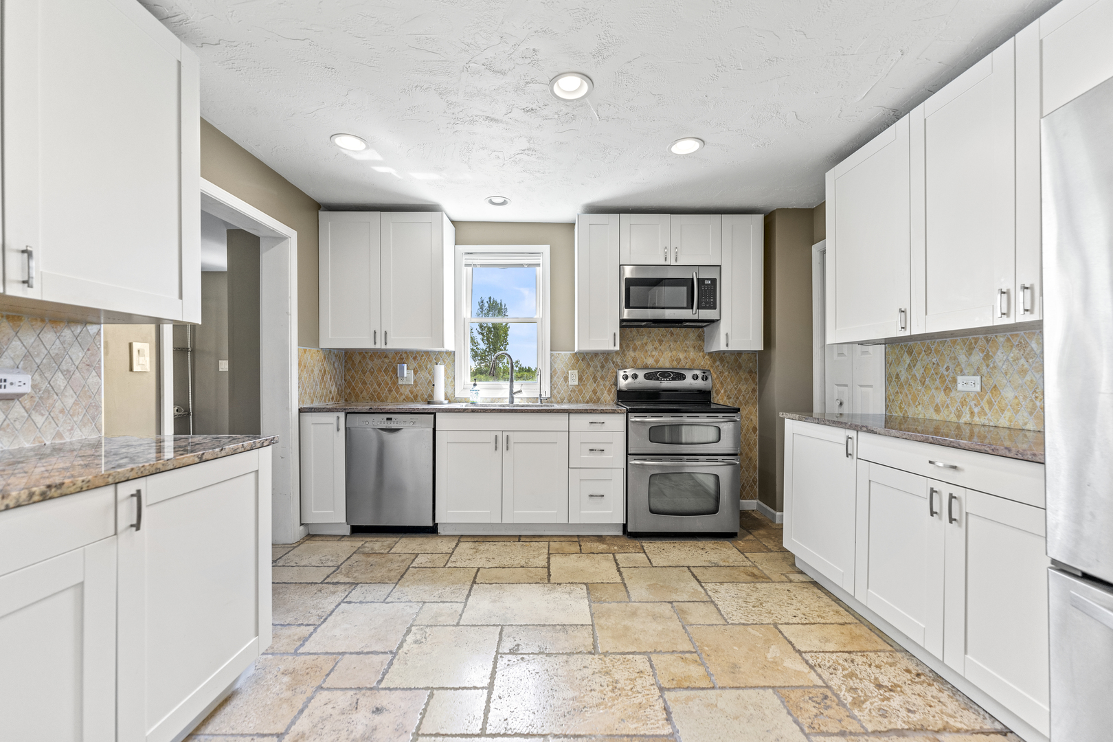 7496 Wolf Road Kingston, IL 60145 - Photo 3 of 38 a kitchen with stainless steel appliances granite countertop a stove a sink and a refrigerator