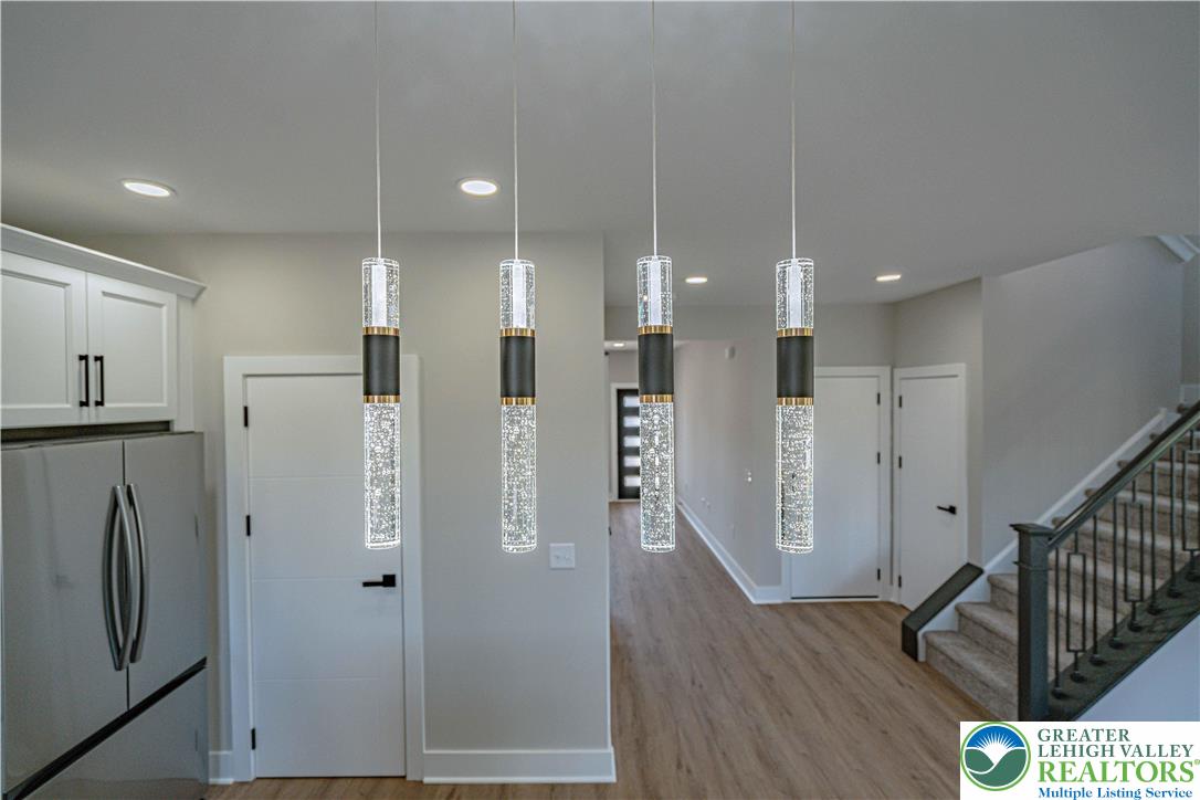 261 Maple Street Coplay, PA 18037 - Photo 14 of 53 a view of a hallway with wooden floor and a refrigerator