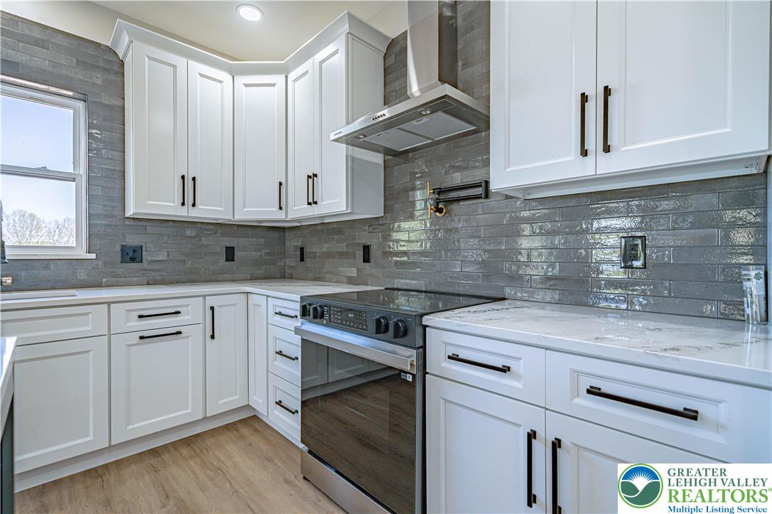 261 Maple Street Coplay, PA 18037 - Photo 15 of 53 a kitchen with cabinets appliances a sink and a counter