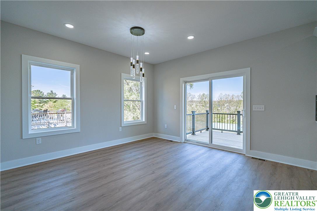 261 Maple Street Coplay, PA 18037 - Photo 20 of 53 a view of an empty room with wooden floor and a window