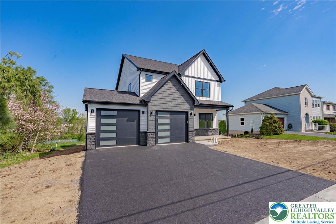 261 Maple Street Coplay, PA 18037 - Photo 2 of 53 a front view of a house with a yard and garage