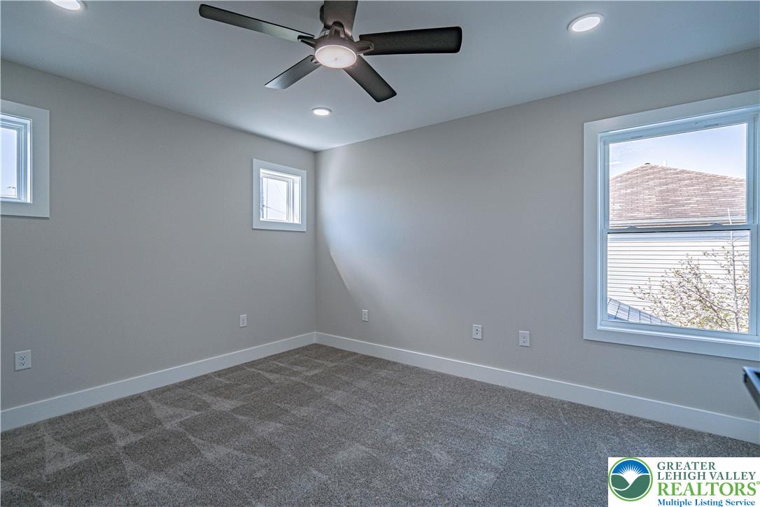 261 Maple Street Coplay, PA 18037 - Photo 33 of 53 an empty room with a window and a fan