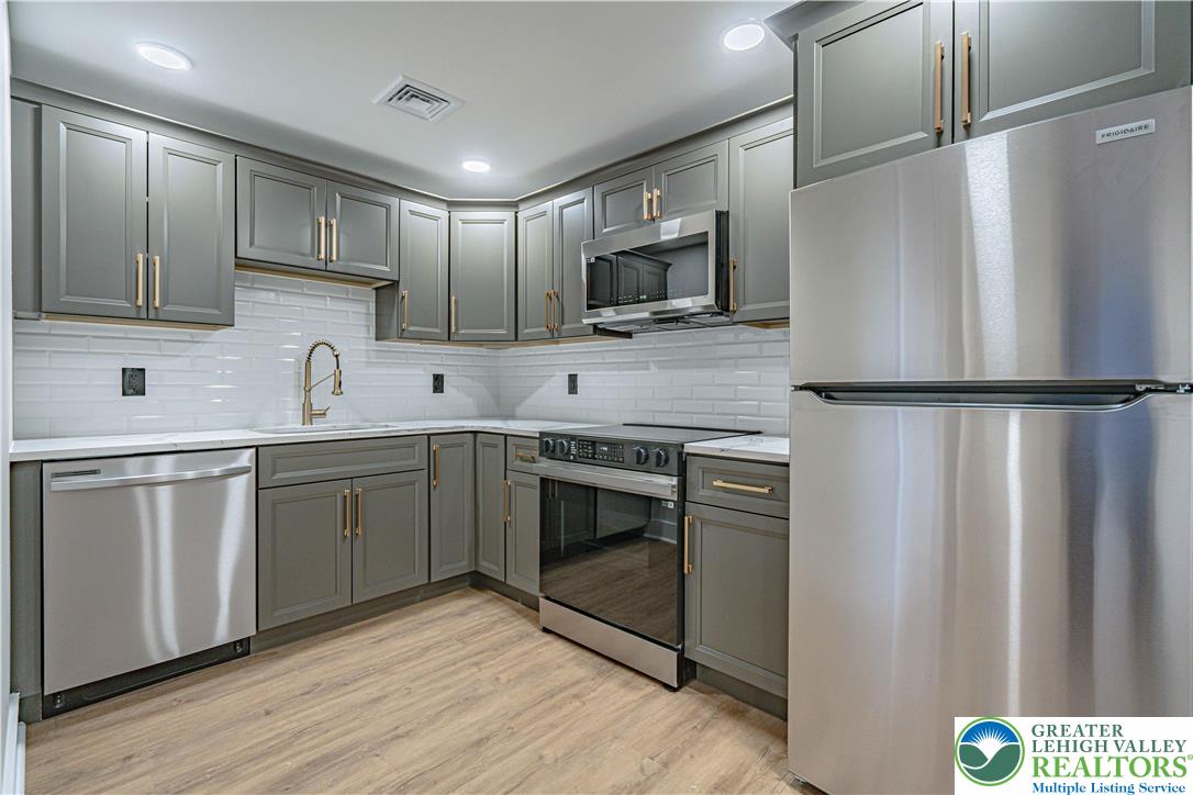 261 Maple Street Coplay, PA 18037 - Photo 38 of 53 a kitchen with stainless steel appliances a stove microwave and sink