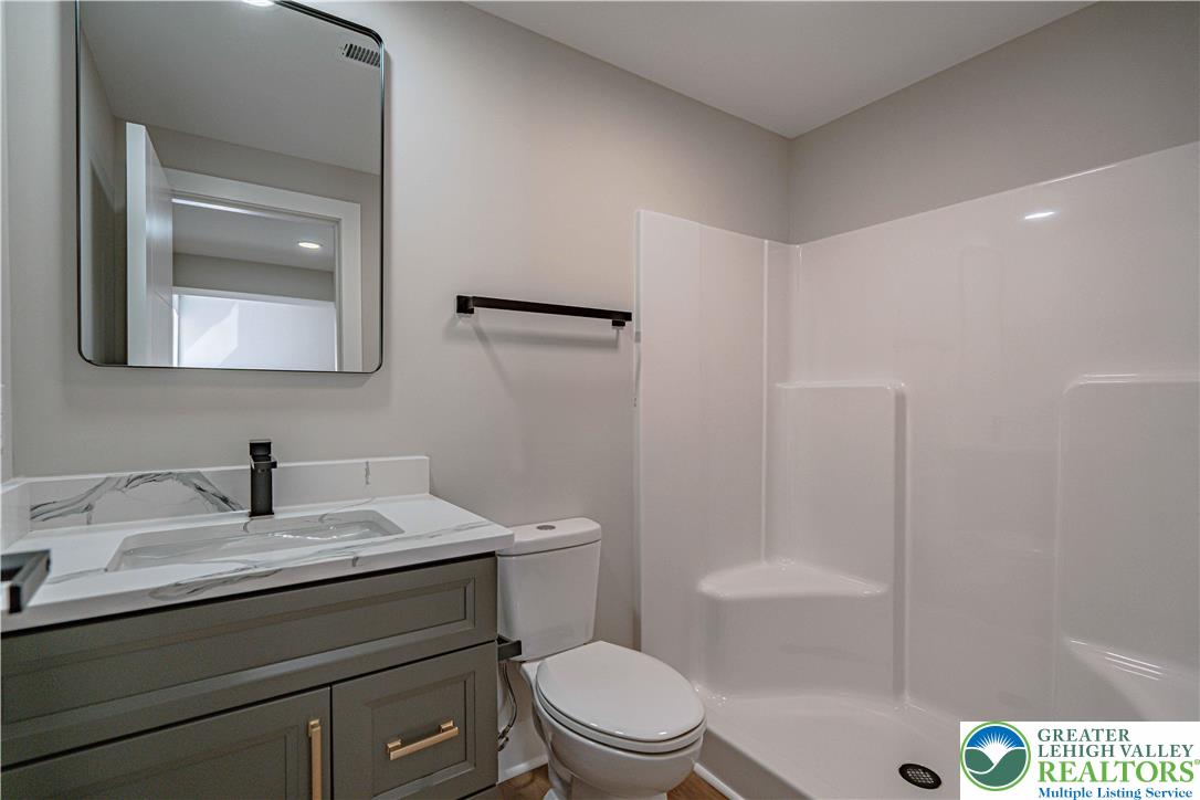 261 Maple Street Coplay, PA 18037 - Photo 41 of 53 a bathroom with a sink a toilet a mirror and shower