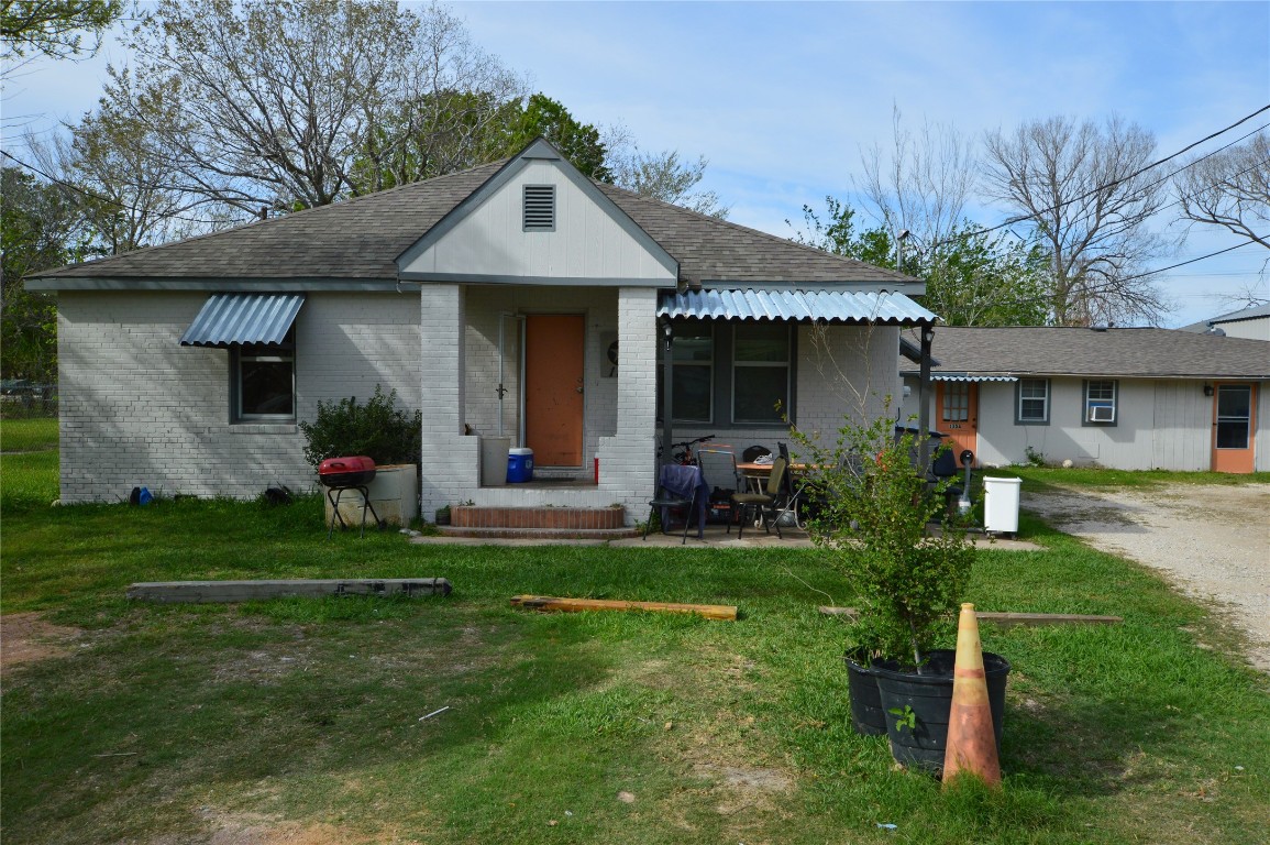a front view of a house with a yard and porch