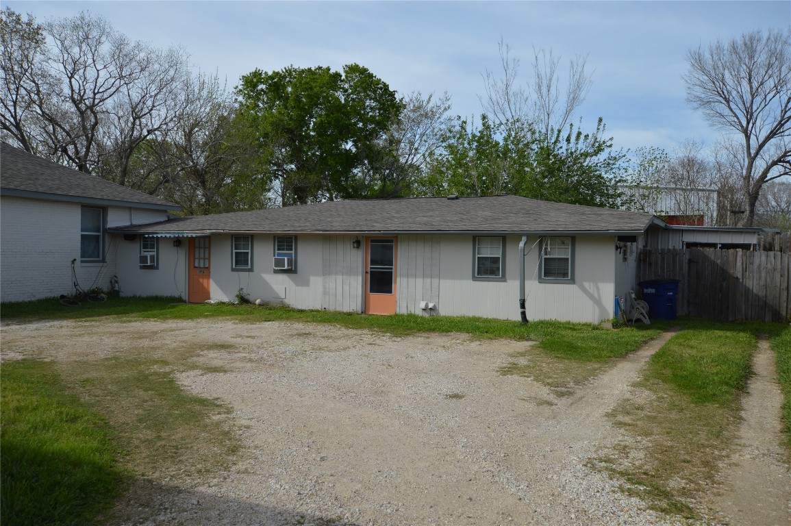 135 West 5th Street Kemah, TX 77565 - Photo 5 of 10 a front view of a house with a garden and trees