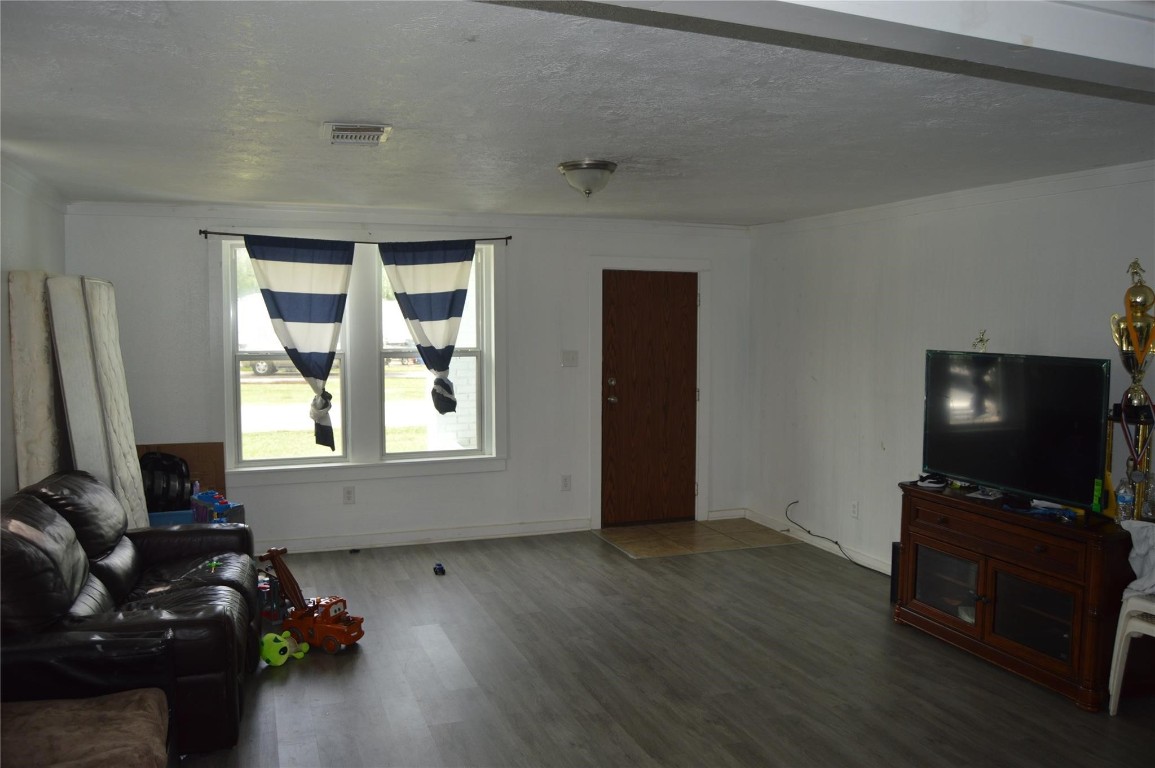 135 West 5th Street Kemah, TX 77565 - Photo 8 of 10 a living room with furniture and a flat screen tv
