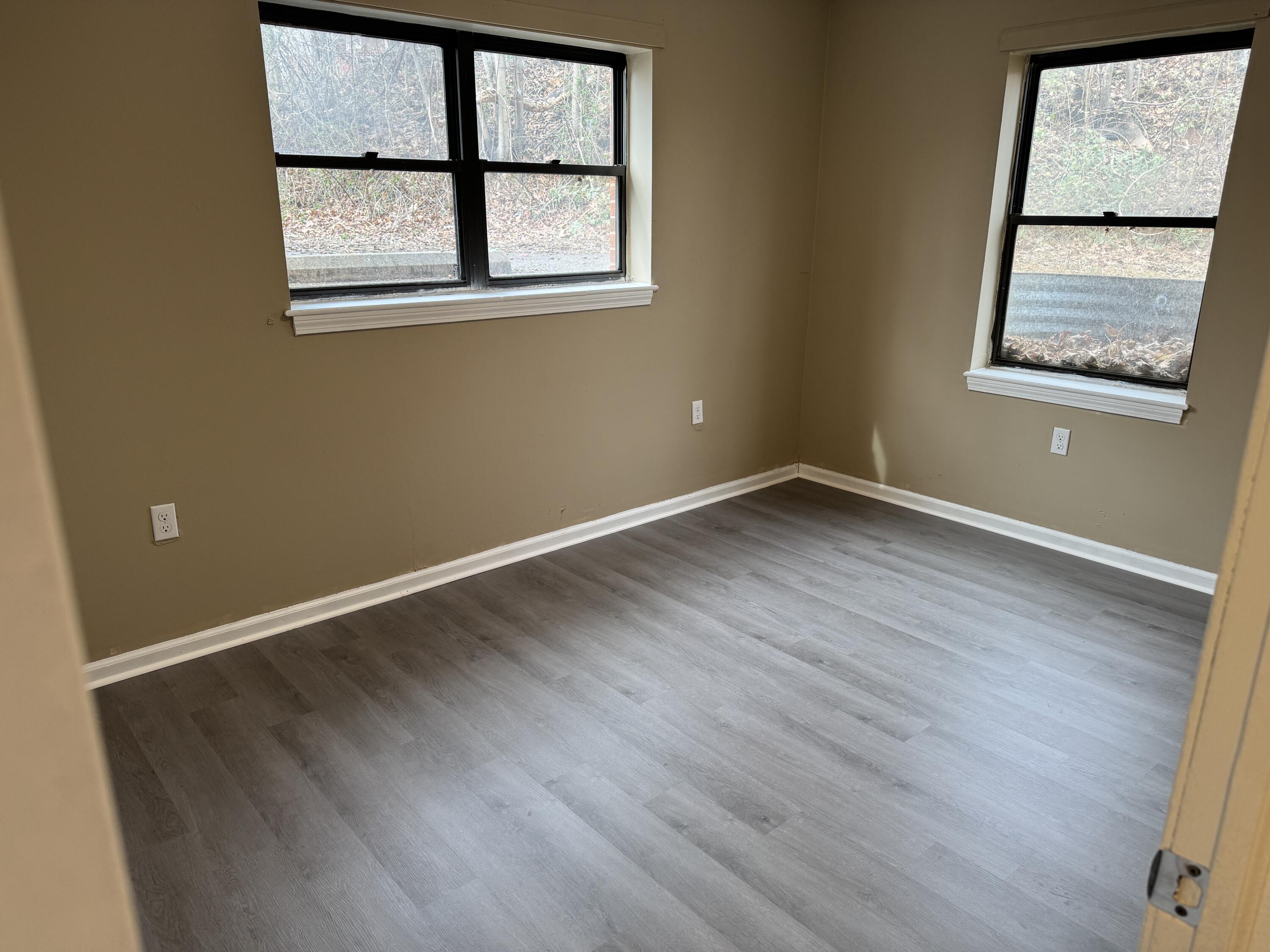45 Vera Avenue, Unit 6 Collinsville, VA 24078 - Photo 8 of 8 an empty room with wooden floor and windows