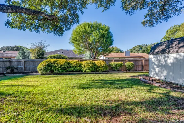 a view of a park with iron fence