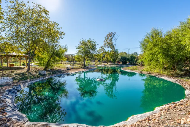 a view of a lake with houses in the back