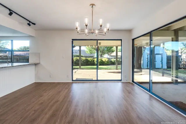 a view of a kitchen with a dishwasher cabinets and a floor to ceiling window
