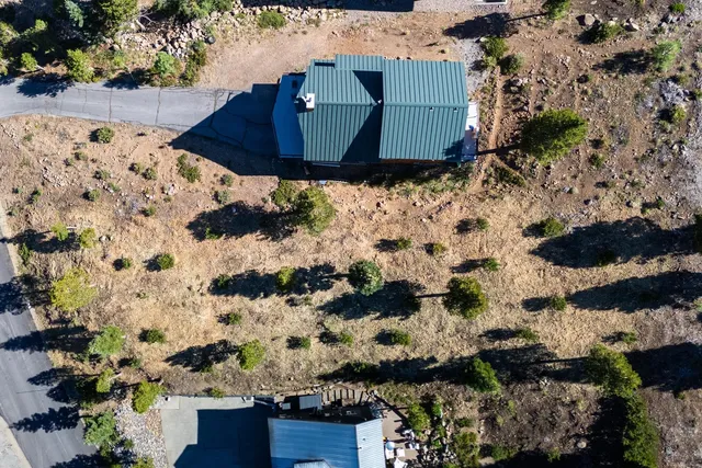 a view of a house with a big yard and large tree