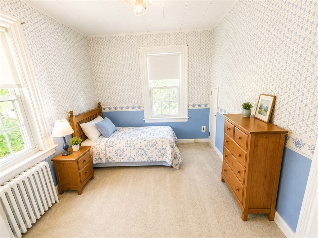 36 Plummer Avenue Lowell, MA 01852 - Photo 17 of 23 a spacious bedroom with a bed and wooden floor
