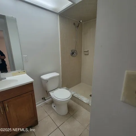 a bathroom with a toilet a sink and shower
