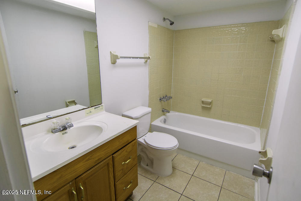 5138 Ricker Road, Unit 2 Jacksonville, FL 32210 - Photo 13 of 17 a bathroom with a sink and a mirror