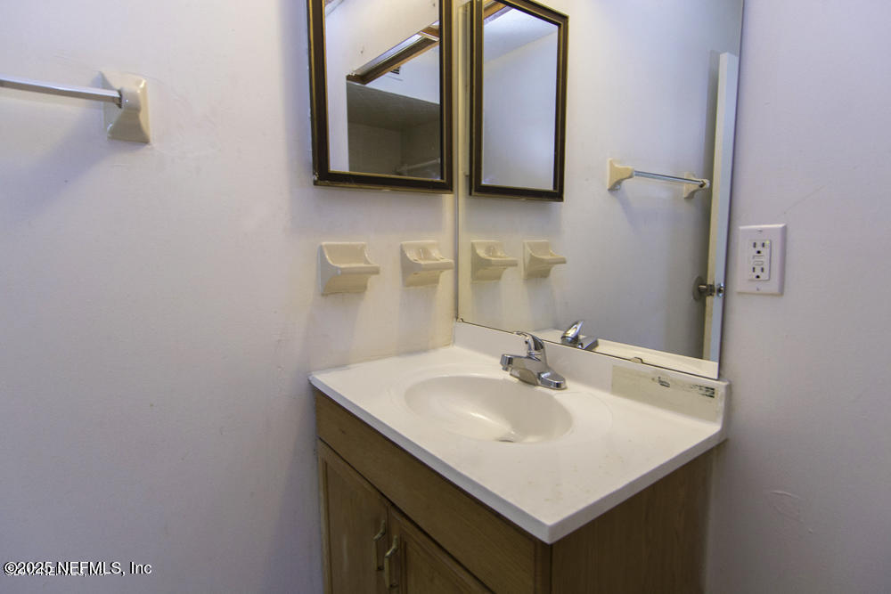 5138 Ricker Road, Unit 2 Jacksonville, FL 32210 - Photo 14 of 17 a bathroom with a sink and a mirror