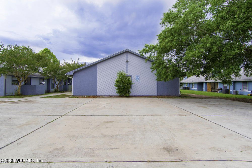 5138 Ricker Road, Unit 2 Jacksonville, FL 32210 - Photo 15 of 17 a front view of house with yard and green space