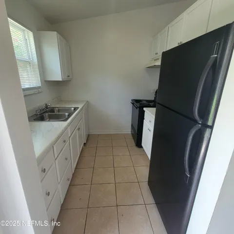 a kitchen with a sink and a stove top oven