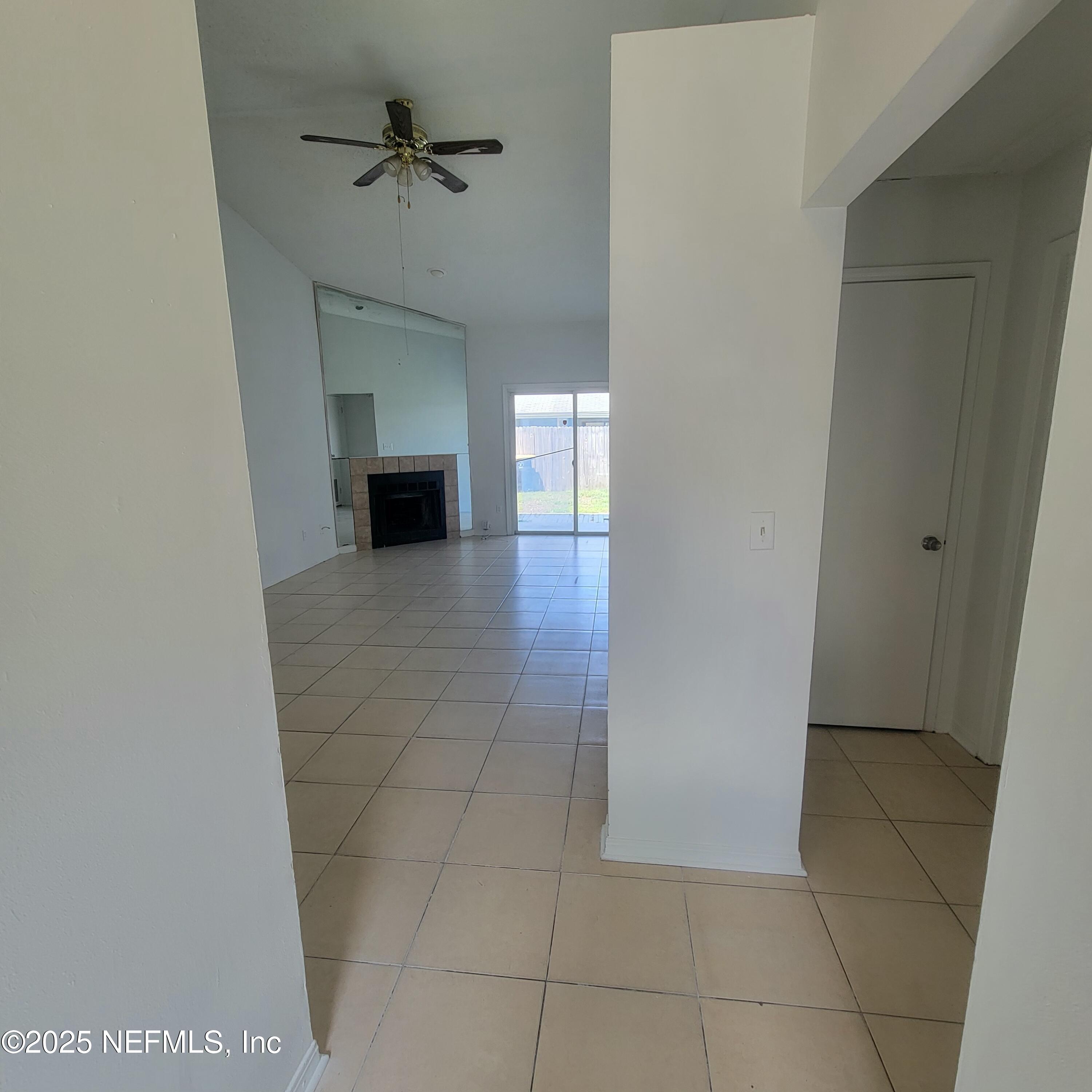 5138 Ricker Road, Unit 2 Jacksonville, FL 32210 - Photo 4 of 17 a view of a livingroom with a fireplace and a chandelier fan