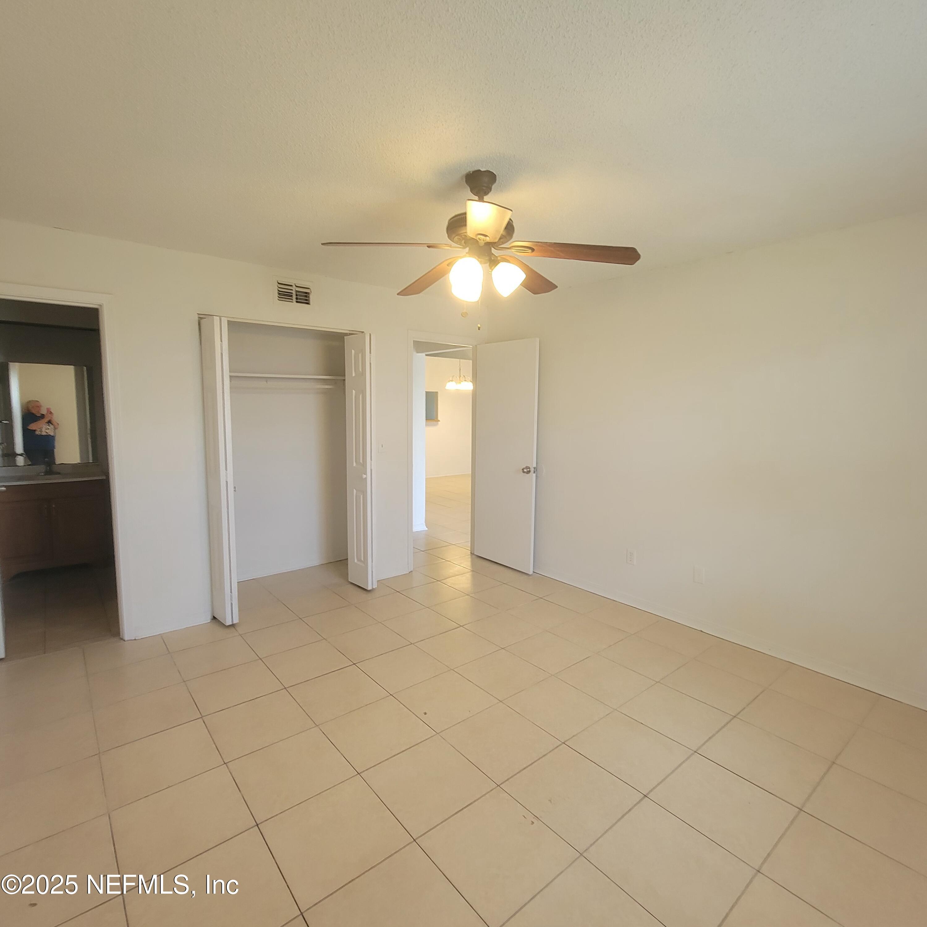 5138 Ricker Road, Unit 2 Jacksonville, FL 32210 - Photo 10 of 17 a view of an empty room and chandelier fan