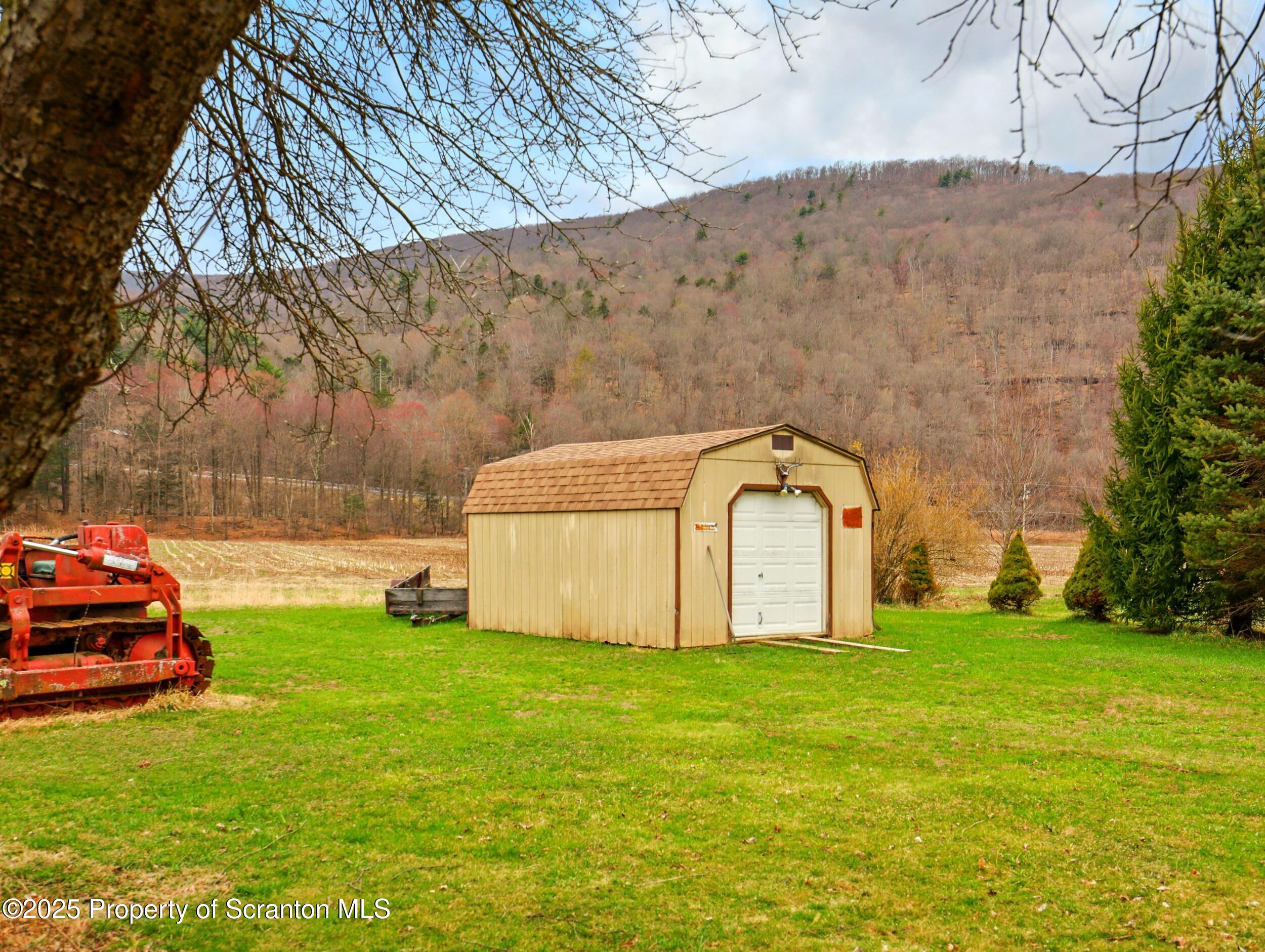 110 Bluegrass Road Tunkhannock, PA 18657 - Photo 17 of 17 a view of a garden with large trees