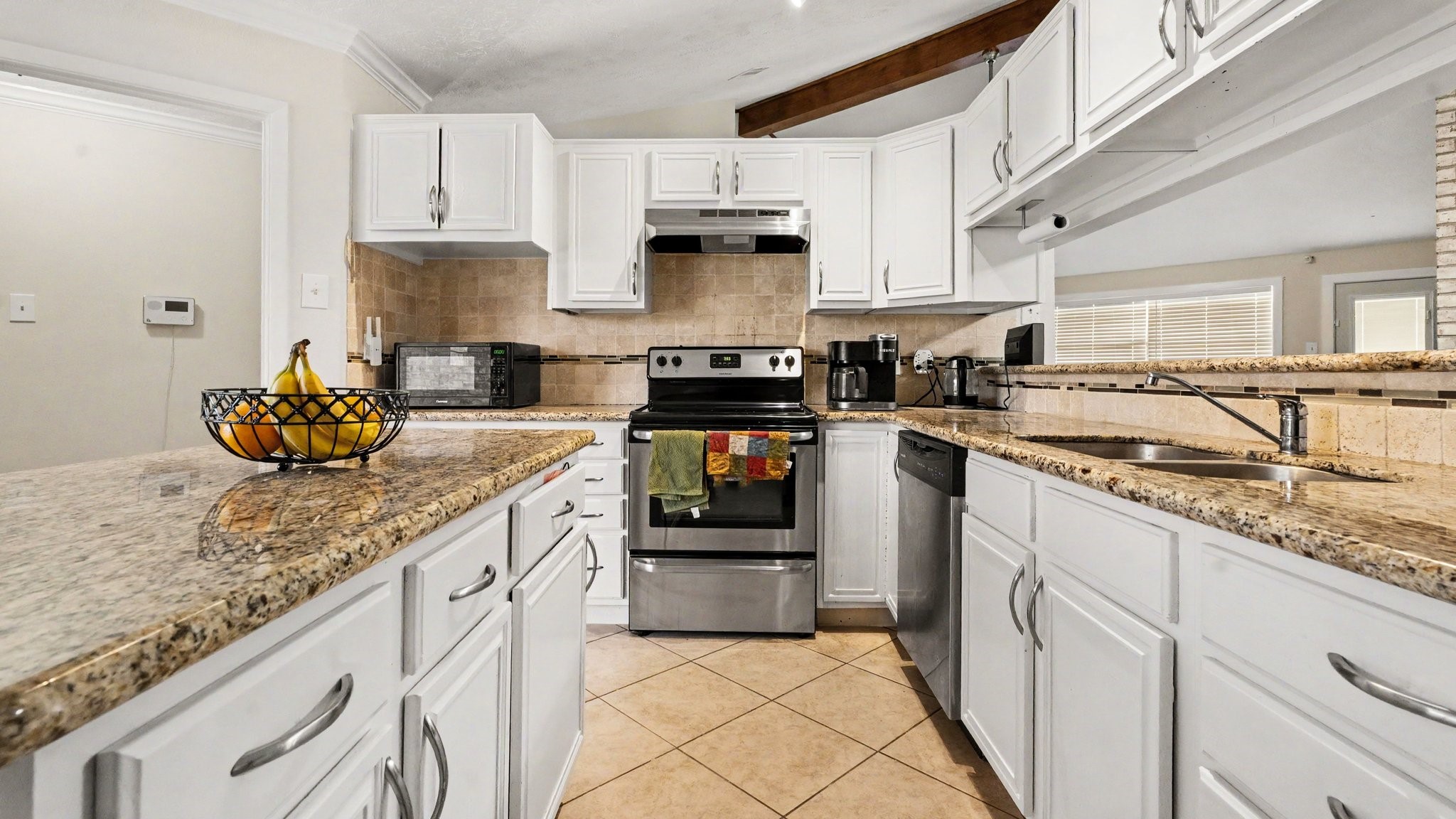 1506 Holbech Lane Channelview, TX 77530 - Photo 7 of 21 a kitchen with stainless steel appliances granite countertop a stove a sink and a granite counter tops