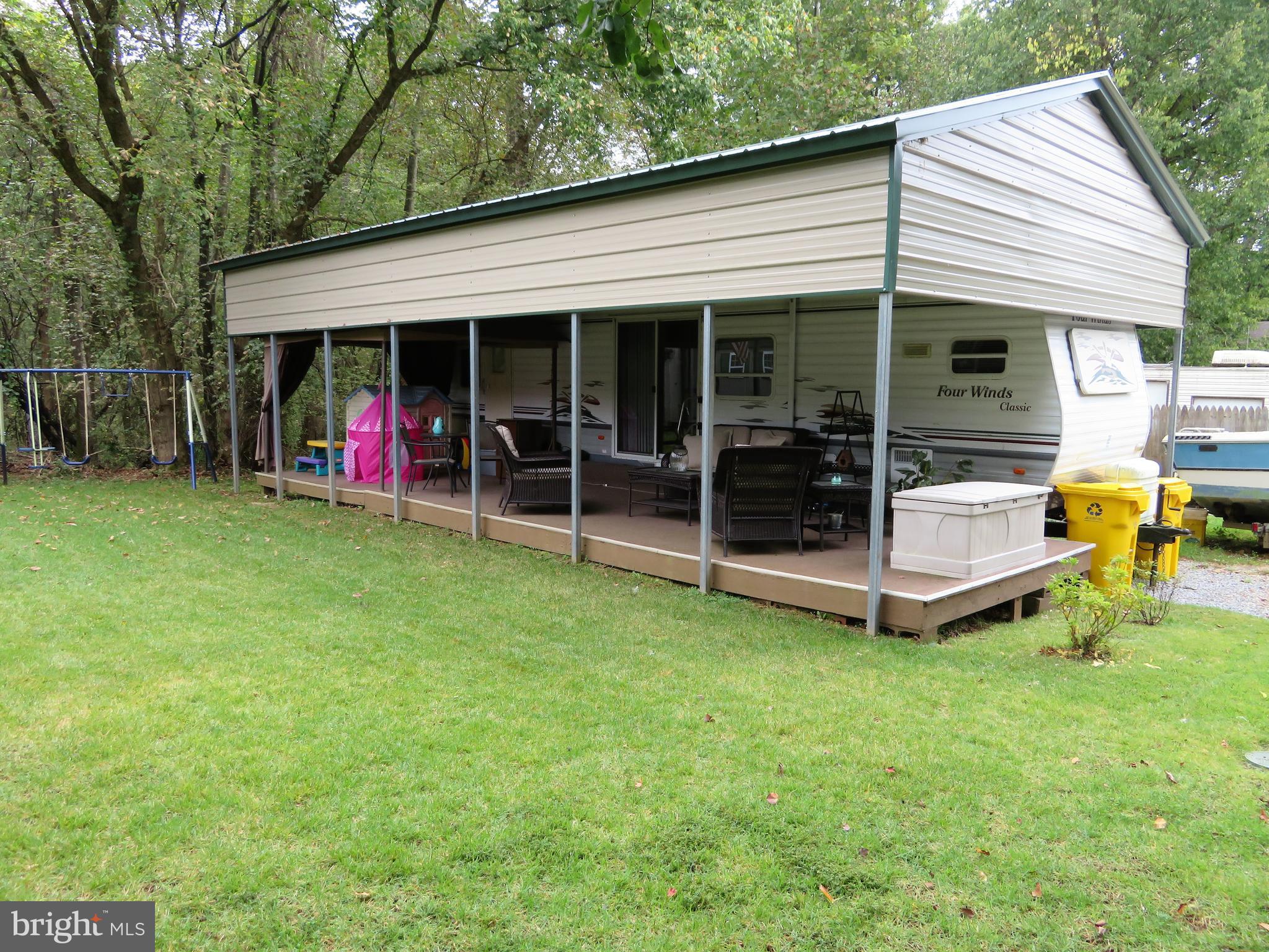 24 Ranger Road Falling Waters, WV 25419 - Photo 1 of 27 a view of a house with backyard porch and sitting area