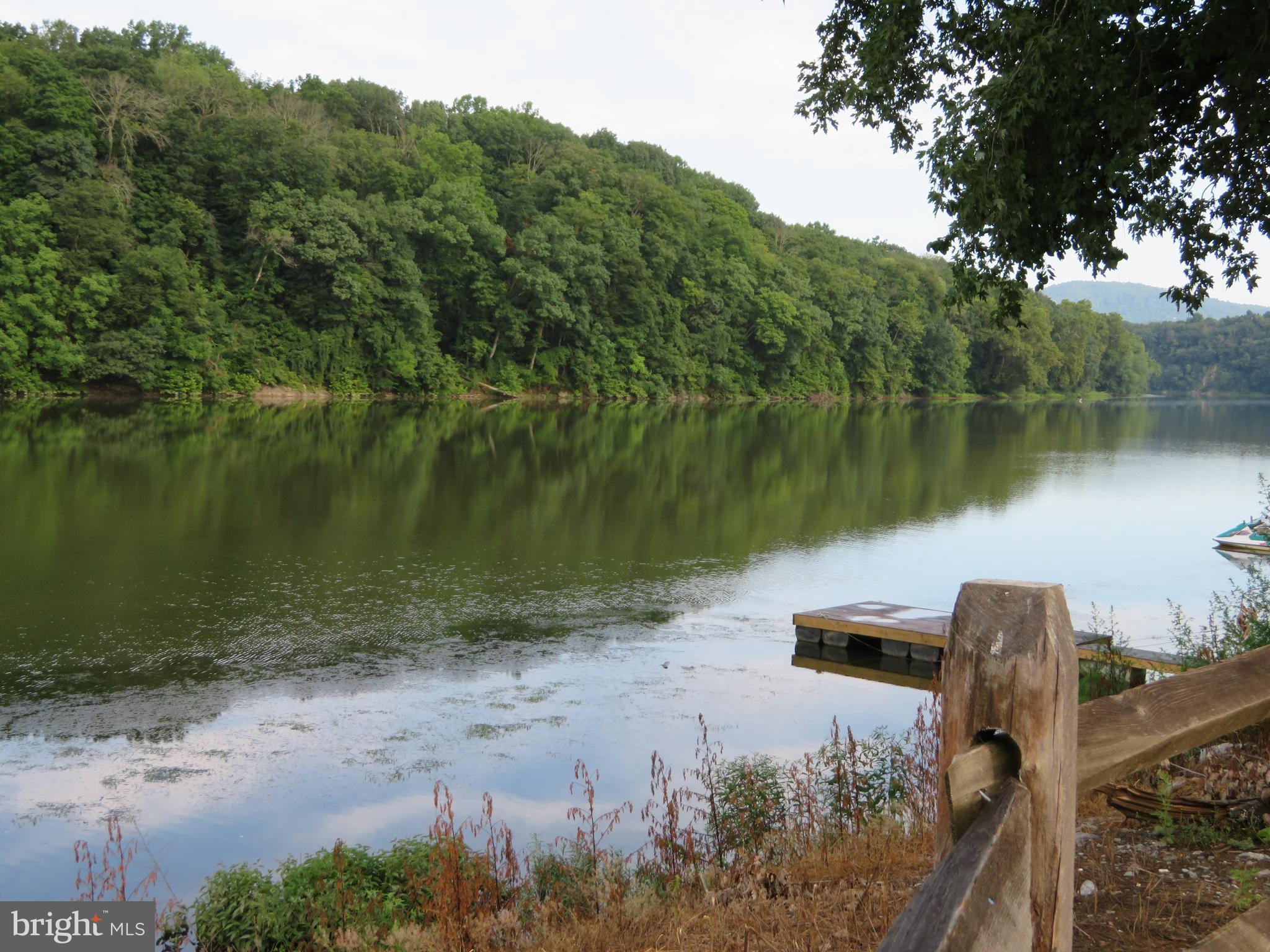 24 Ranger Road Falling Waters, WV 25419 - Photo 27 of 27 a view of a lake in between two large trees
