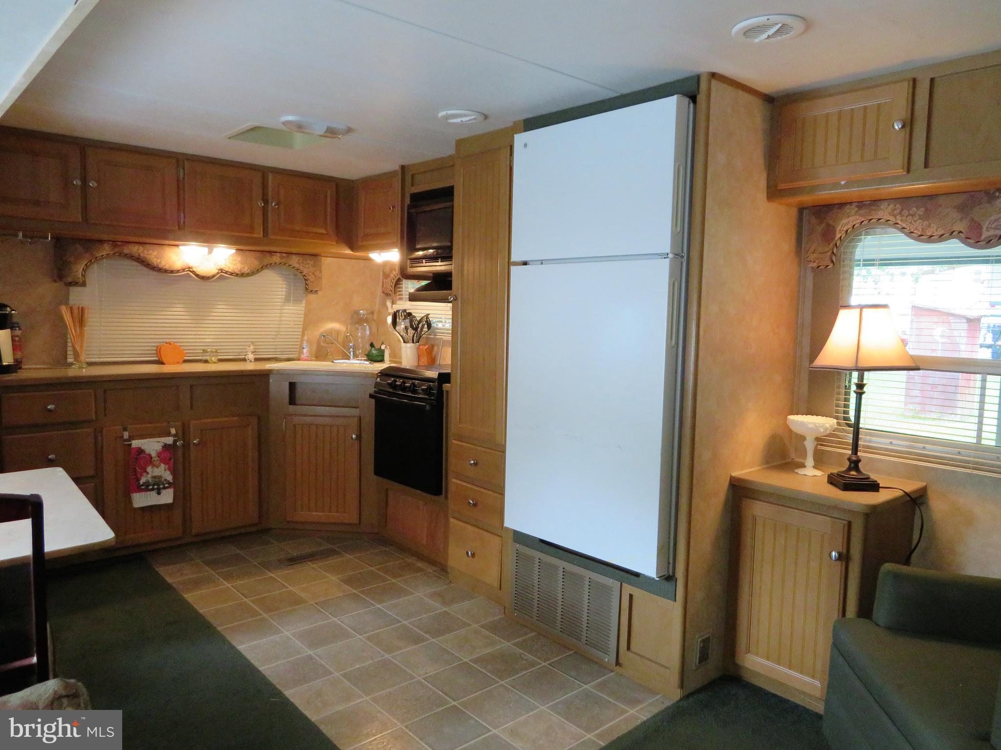 24 Ranger Road Falling Waters, WV 25419 - Photo 4 of 27 a kitchen with stainless steel appliances granite countertop a refrigerator and a sink
