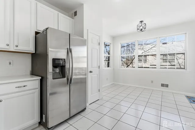 a kitchen with stainless steel appliances a refrigerator and a stove top oven