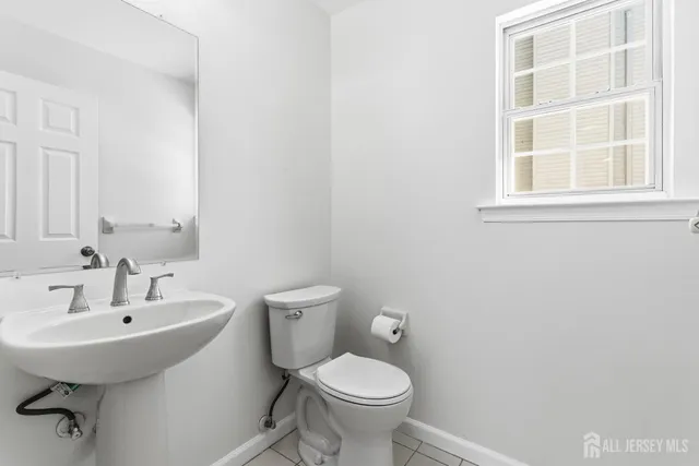 a bathroom with a sink toilet and a mirror