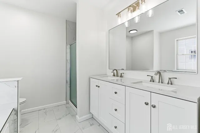 a bathroom with a double vanity sink and mirror