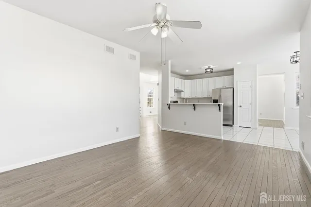 a view of a kitchen with wooden floor and a kitchen