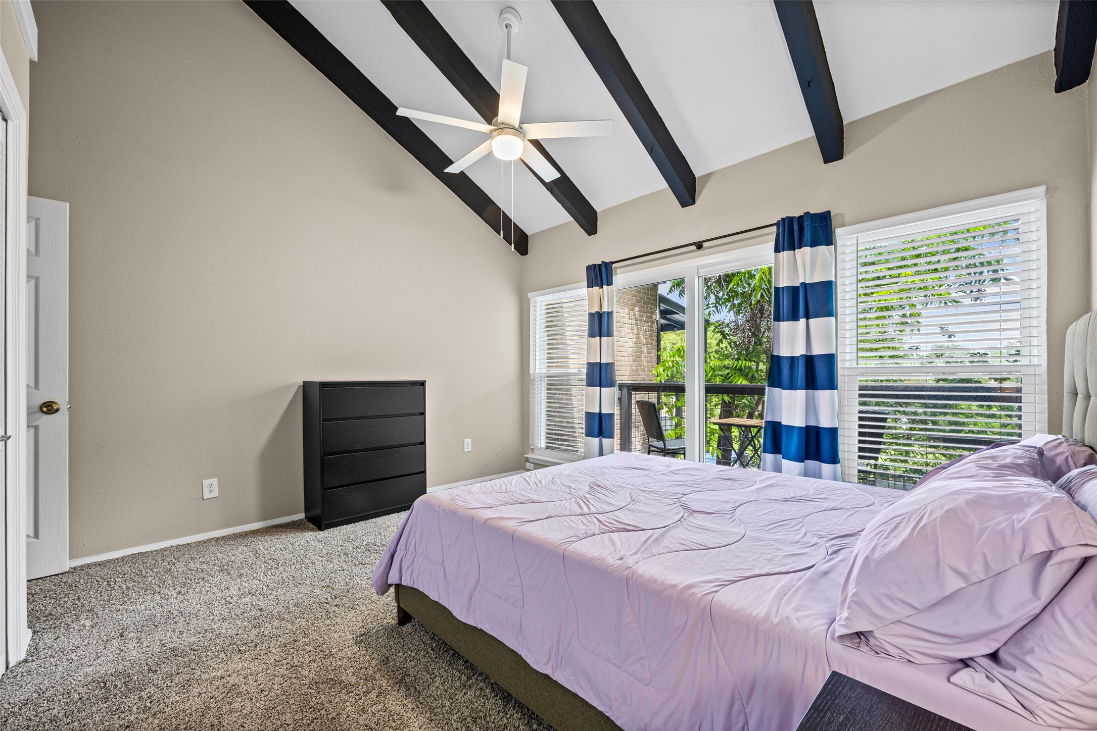 3809 Menchaca Road, Unit C Austin, TX 78704 - Photo 18 of 28 Vaulted ceilings with exposed beams and a private balcony elevate this restful bedroom retreat.