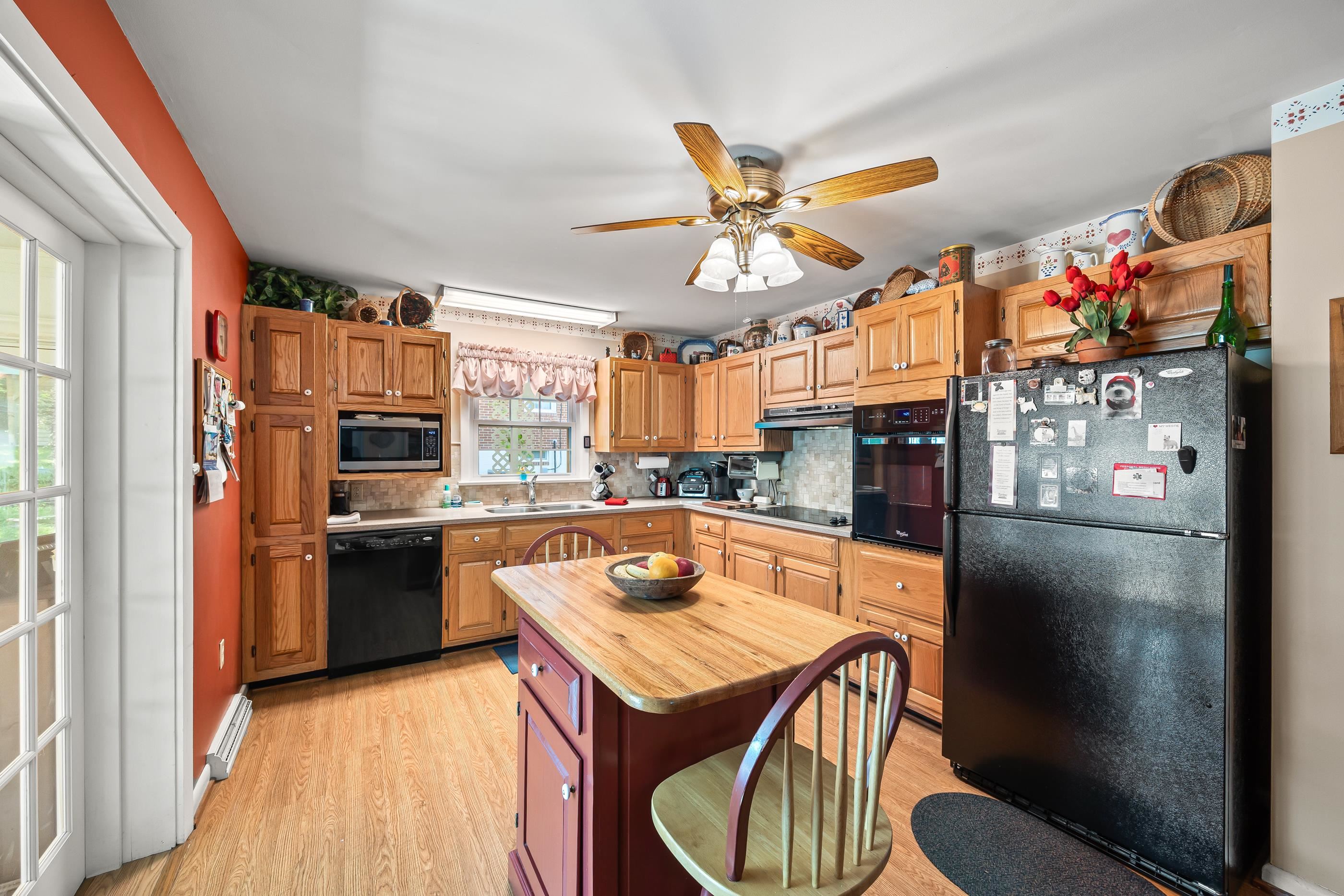 208 Tuxedo Road Staunton, VA 24401 - Photo 16 of 46 a kitchen with stainless steel appliances granite countertop a refrigerator a sink dishwasher a stove and a dining table with wooden floor