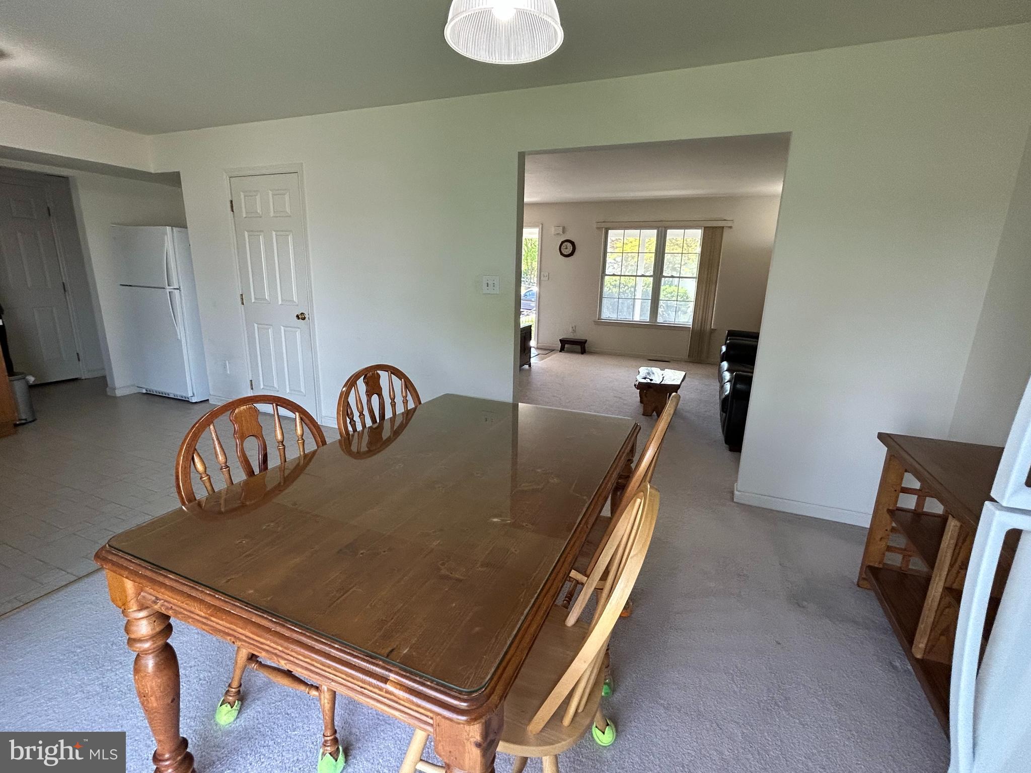 349 Oneida Drive Sinking Spring, PA 19608 - Photo 15 of 35 a room with a table chairs and a refrigerator